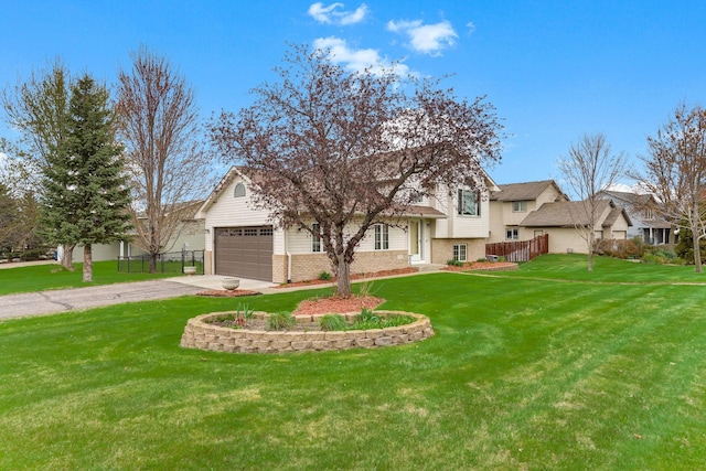 tri-level home featuring driveway, a front yard, a garage, and brick siding