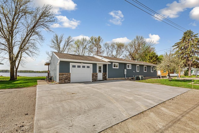 17055 Dickenson Ln, Waterville, MN 56096 - ranch-style house with a garage, driveway, stone siding, a water view, and central air condition unit