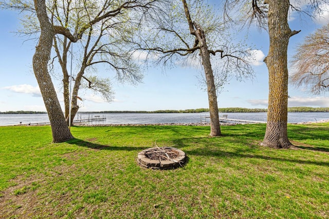 17055 Dickenson Ln, Waterville, MN 56096 - view of grassy yard with an outdoor fire pit and a water view