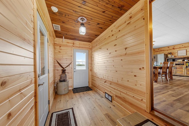 17055 Dickenson Ln, Waterville, MN 56096 - doorway with wood walls, light wood finished floors, and wood ceiling