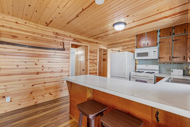17055 Dickenson Ln, Waterville, MN 56096 - kitchen with white appliances, a peninsula, wooden ceiling, a sink, and brown cabinets