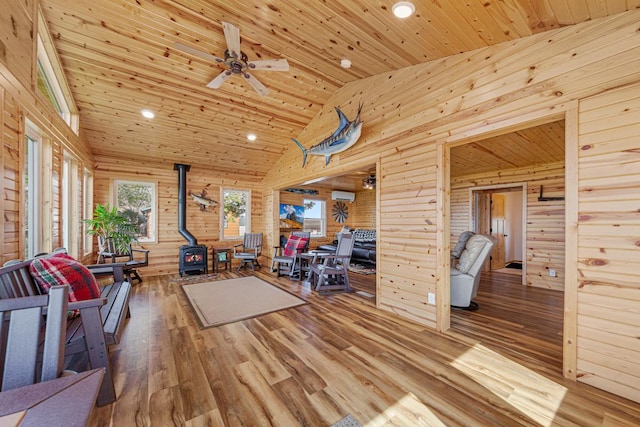 17055 Dickenson Ln, Waterville, MN 56096 - living room featuring a wood stove, wood ceiling, wood finished floors, recessed lighting, and wooden walls