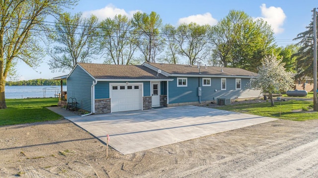 17055 Dickenson Ln, Waterville, MN 56096 - single story home featuring an attached garage, concrete driveway, cooling unit, a front yard, and stone siding