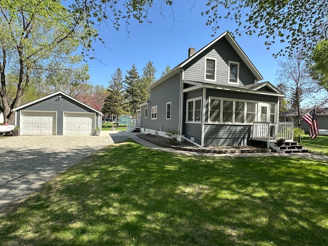 403 7th St N, Kerkhoven, MN 56252 - view of side of property with a chimney, an outdoor structure, a garage, a sunroom, and a lawn