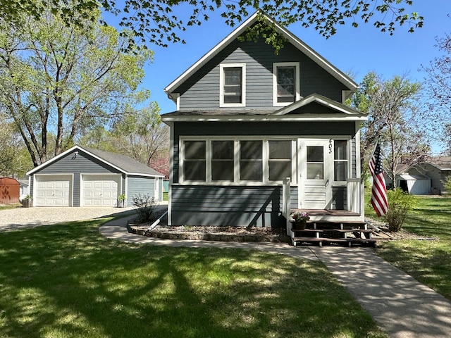 403 7th St N, Kerkhoven, MN 56252 - view of front of home with an outbuilding, a detached garage, and a front lawn