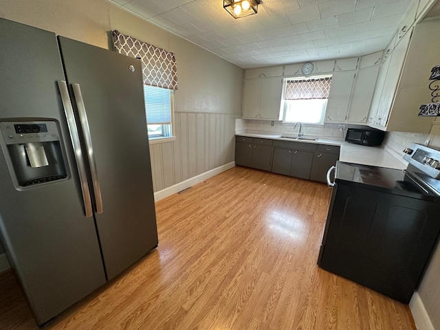 403 7th St N, Kerkhoven, MN 56252 - kitchen with stainless steel fridge with ice dispenser, electric range, a sink, light countertops, and light wood-style flooring