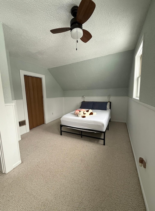 403 7th St N, Kerkhoven, MN 56252 - carpeted bedroom with a textured ceiling, lofted ceiling, and ceiling fan