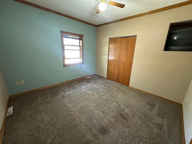 403 7th St N, Kerkhoven, MN 56252 - unfurnished bedroom featuring crown molding, carpet, baseboards, a closet, and a ceiling fan