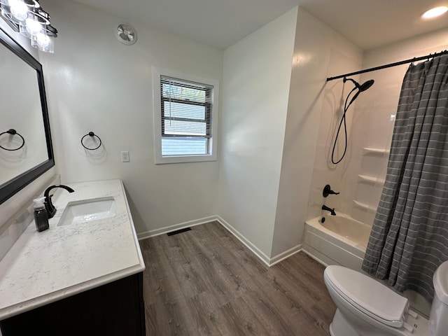 403 7th St N, Kerkhoven, MN 56252 - full bath featuring wood finished floors, toilet, baseboards, vanity, and shower / bath combo with shower curtain