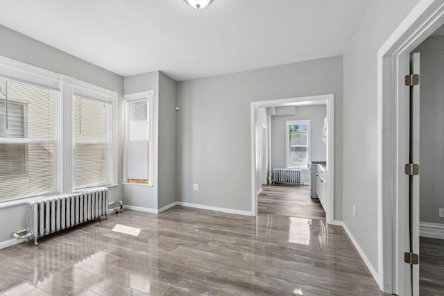852 Edmund Ave, Saint Paul, MN 55104 - unfurnished room featuring radiator heating unit, wood finished floors, and baseboards