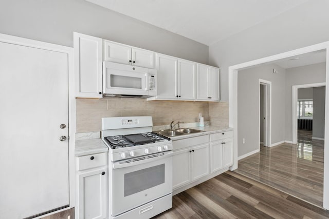 852 Edmund Ave, Saint Paul, MN 55104 - kitchen with white appliances, a sink, decorative backsplash, and white cabinetry