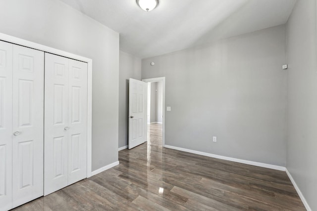 852 Edmund Ave, Saint Paul, MN 55104 - unfurnished bedroom with wood finished floors, baseboards, and a closet
