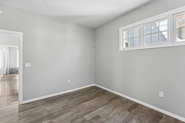 852 Edmund Ave, Saint Paul, MN 55104 - empty room with baseboards, radiator heating unit, and wood finished floors
