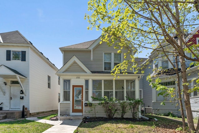 852 Edmund Ave, Saint Paul, MN 55104 - traditional-style home with a sunroom, roof with shingles, and central AC unit