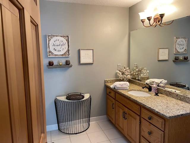 58 Garden Dr, Burnsville, MN 55337 - bathroom with tile patterned floors, a chandelier, vanity, and baseboards
