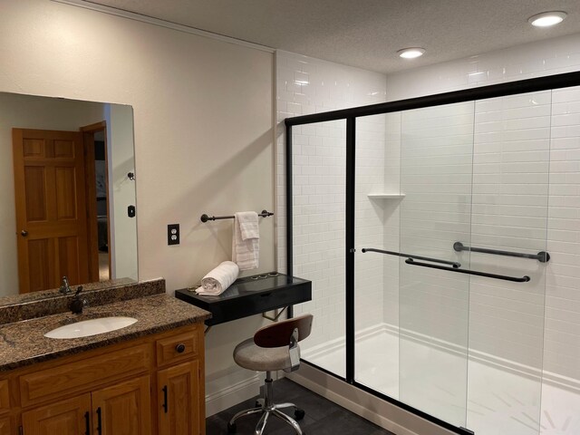 58 Garden Dr, Burnsville, MN 55337 - bathroom featuring a stall shower, a textured ceiling, vanity, recessed lighting, and tile patterned floors