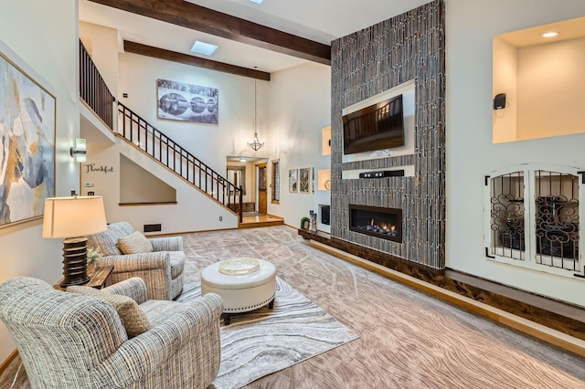 58 Garden Dr, Burnsville, MN 55337 - living area with a high ceiling, beamed ceiling, a fireplace, baseboards, and stairs