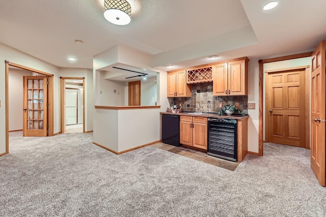 58 Garden Dr, Burnsville, MN 55337 - kitchen featuring wine cooler, black dishwasher, light carpet, baseboards, and tasteful backsplash