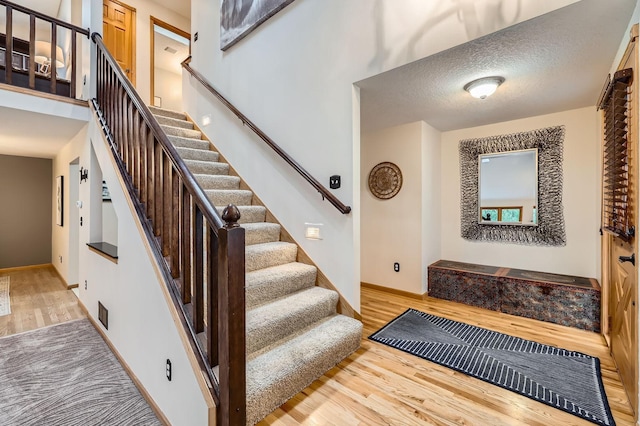 58 Garden Dr, Burnsville, MN 55337 - stairs featuring wood finished floors and baseboards