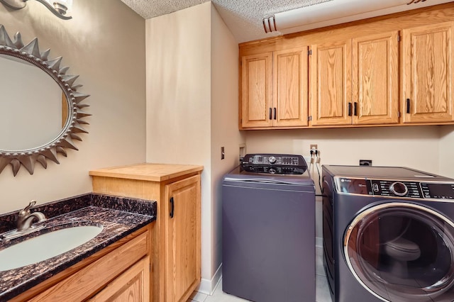 58 Garden Dr, Burnsville, MN 55337 - washroom with a sink, washer and dryer, a textured ceiling, and light tile patterned floors