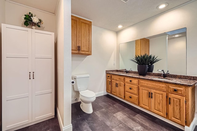 58 Garden Dr, Burnsville, MN 55337 - bathroom with toilet, double vanity, baseboards, recessed lighting, and ornamental molding