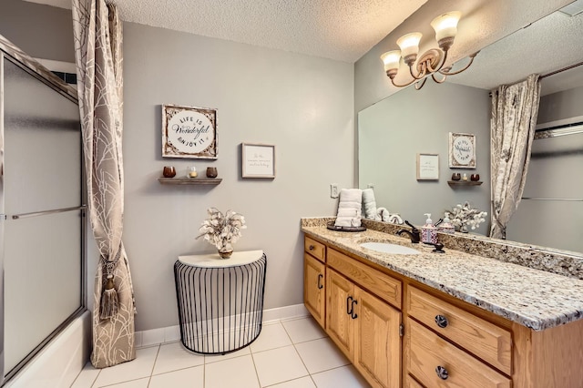 58 Garden Dr, Burnsville, MN 55337 - full bathroom with tile patterned floors, vanity, shower / bath combination with glass door, a textured ceiling, and baseboards