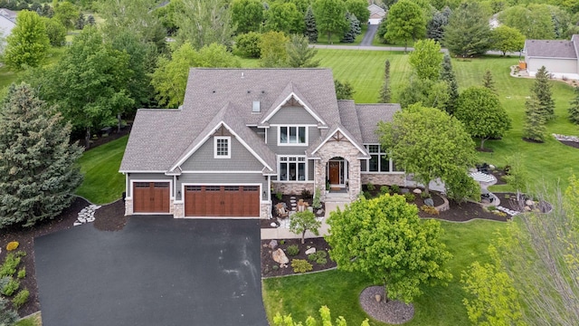 19820 Schutte Farm Rd, Corcoran, MN 55340 - view of front of house with stone siding, asphalt driveway, and a front lawn