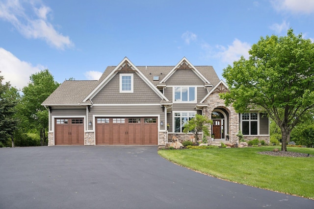 19820 Schutte Farm Rd, Corcoran, MN 55340 - craftsman-style house featuring stone siding, asphalt driveway, a front lawn, and a garage
