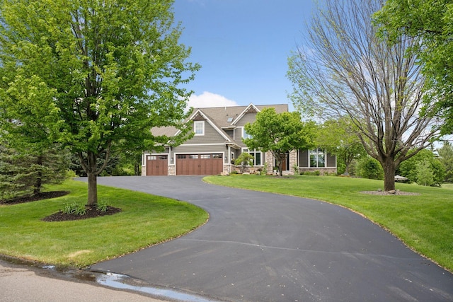 19820 Schutte Farm Rd, Corcoran, MN 55340 - view of front facade with stone siding, asphalt driveway, a front lawn, and an attached garage