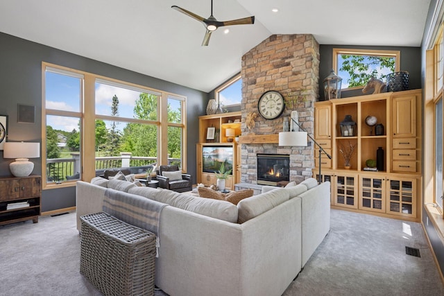 19820 Schutte Farm Rd, Corcoran, MN 55340 - carpeted living room featuring a ceiling fan, a stone fireplace, and high vaulted ceiling