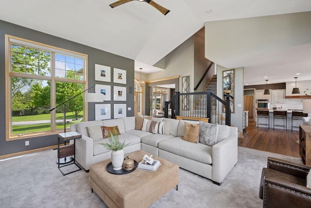 19820 Schutte Farm Rd, Corcoran, MN 55340 - living room featuring plenty of natural light, stairs, a ceiling fan, baseboards, and high vaulted ceiling