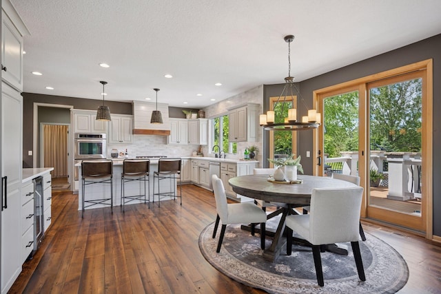 19820 Schutte Farm Rd, Corcoran, MN 55340 - dining space with dark wood-style flooring, wine cooler, a chandelier, and recessed lighting