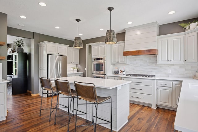 19820 Schutte Farm Rd, Corcoran, MN 55340 - kitchen with appliances with stainless steel finishes, a center island, a breakfast bar area, custom exhaust hood, and tasteful backsplash