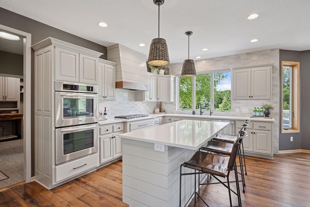 19820 Schutte Farm Rd, Corcoran, MN 55340 - kitchen featuring stainless steel appliances, backsplash, light countertops, dark wood-style flooring, and recessed lighting