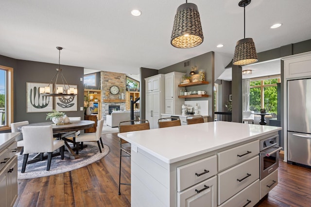 19820 Schutte Farm Rd, Corcoran, MN 55340 - kitchen with appliances with stainless steel finishes, open shelves, white cabinetry, dark wood-type flooring, and recessed lighting