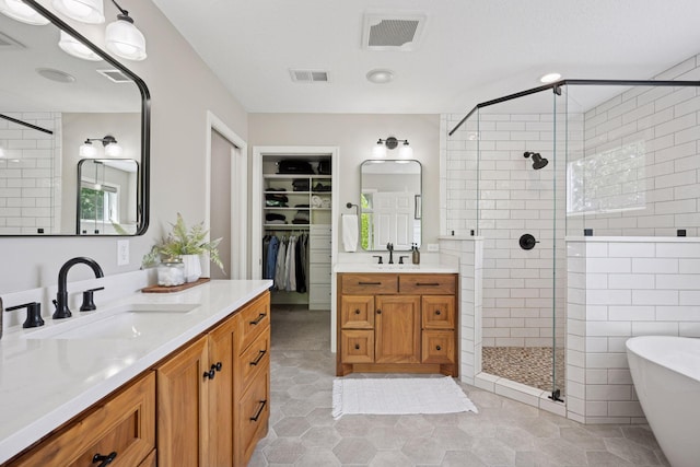 19820 Schutte Farm Rd, Corcoran, MN 55340 - bathroom with a stall shower, two vanities, a soaking tub, a walk in closet, and tile patterned floors