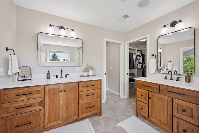19820 Schutte Farm Rd, Corcoran, MN 55340 - full bath featuring two vanities, a spacious closet, and baseboards