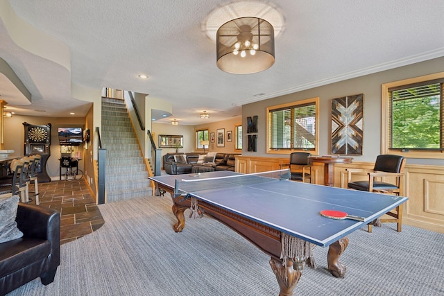 19820 Schutte Farm Rd, Corcoran, MN 55340 - rec room featuring stone tile floors, a textured ceiling, a wainscoted wall, and recessed lighting