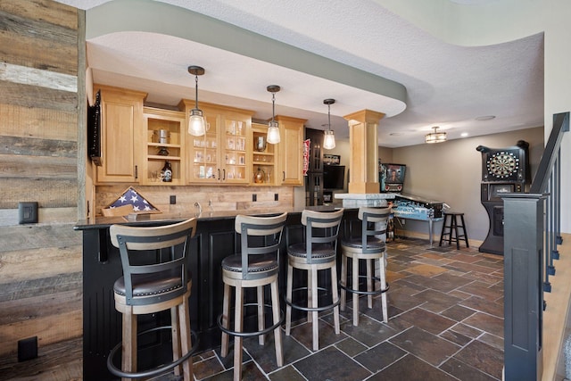 19820 Schutte Farm Rd, Corcoran, MN 55340 - indoor wet bar featuring decorative backsplash, stairway, pendant lighting, baseboards, and dark stone finish flooring