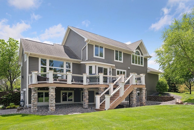 19820 Schutte Farm Rd, Corcoran, MN 55340 - rear view of house featuring a deck, a yard, stairway, roof with shingles, and stone siding