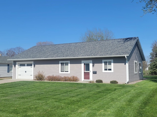 411 Bullis St, Kenyon, MN 55946 - ranch-style house with a front yard, a shingled roof, driveway, and a garage