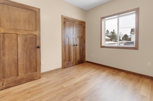 411 Bullis St, Kenyon, MN 55946 - unfurnished bedroom with light wood-style floors and baseboards