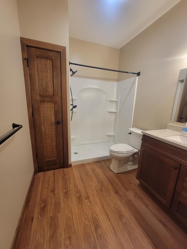 411 Bullis St, Kenyon, MN 55946 - full bathroom featuring a shower, vanity, and wood finished floors