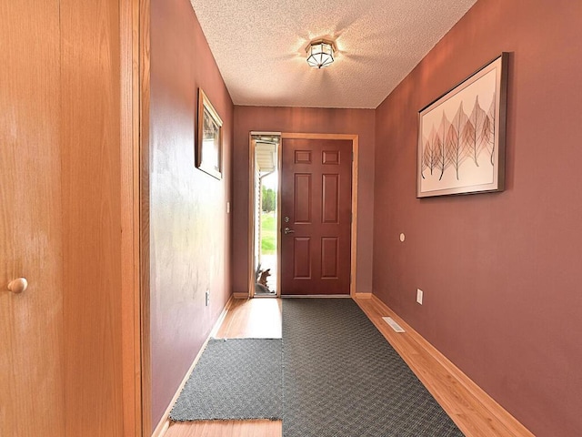 38850 Christie Ln, Cohasset, MN 55721 - entryway with a textured ceiling, baseboards, and wood finished floors