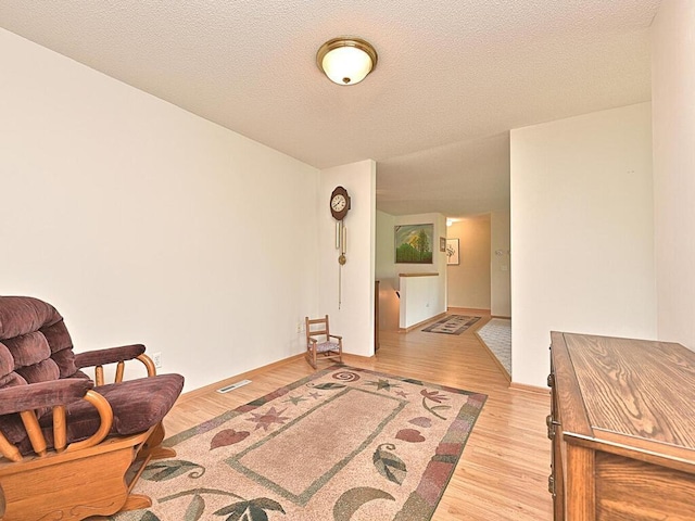 38850 Christie Ln, Cohasset, MN 55721 - sitting room featuring light wood-type flooring and a textured ceiling
