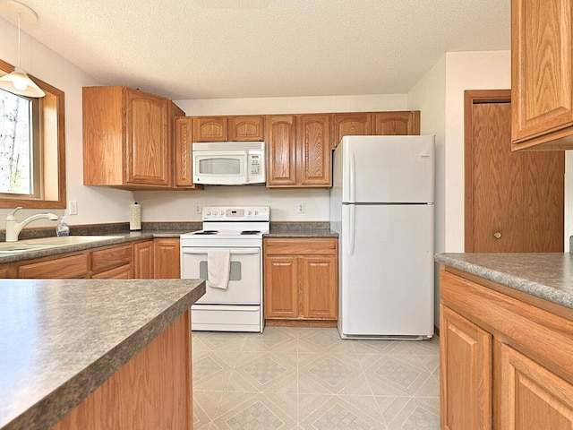 38850 Christie Ln, Cohasset, MN 55721 - kitchen featuring white appliances, a textured ceiling, a sink, dark countertops, and brown cabinets