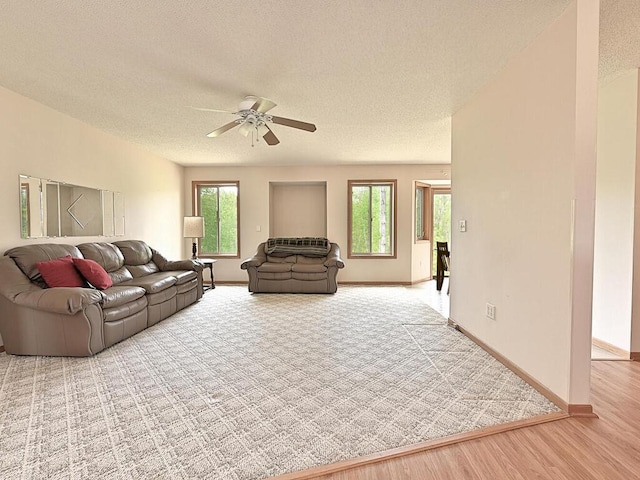 38850 Christie Ln, Cohasset, MN 55721 - living room with a textured ceiling, ceiling fan, plenty of natural light, baseboards, and wood finished floors