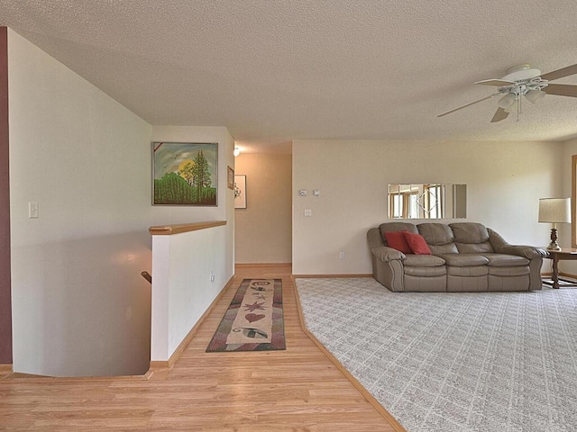 38850 Christie Ln, Cohasset, MN 55721 - living area featuring a textured ceiling, ceiling fan, wood finished floors, and baseboards
