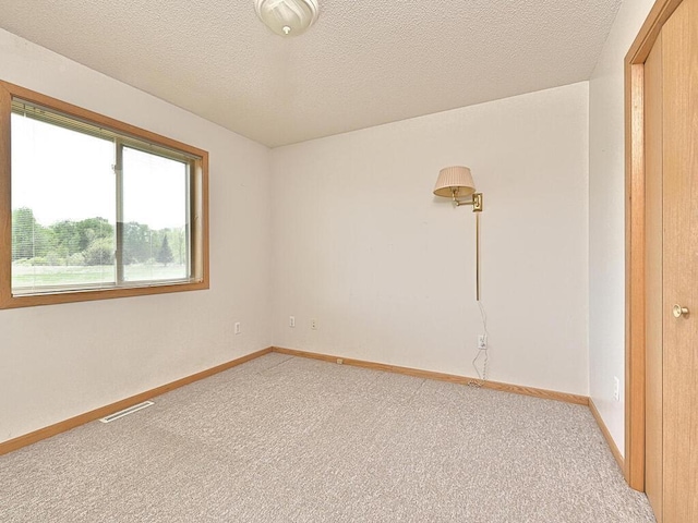 38850 Christie Ln, Cohasset, MN 55721 - spare room with light carpet, baseboards, and a textured ceiling