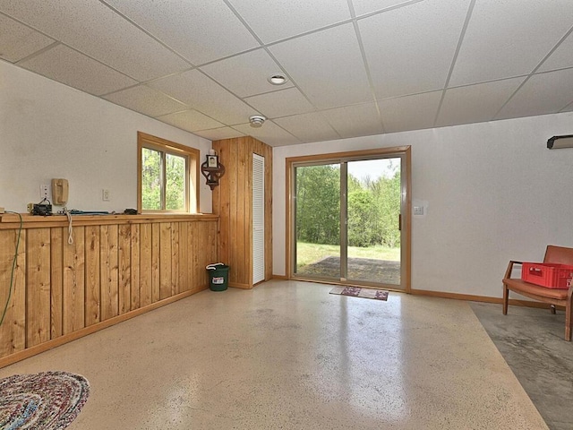 38850 Christie Ln, Cohasset, MN 55721 - empty room with baseboards, a drop ceiling, and wooden walls